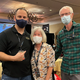 Kim and Craig Cutchin smile behind their face masks as they pose for a photo with Alex Jebailey at CEO 2021.
